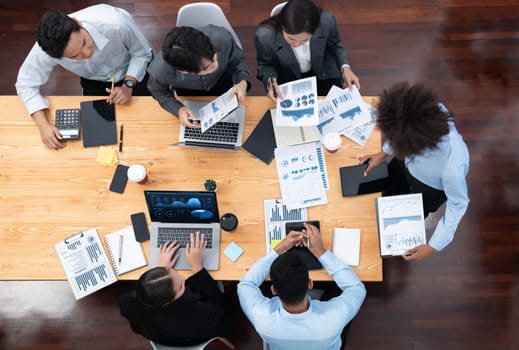 Top view multiracial analyst team use BI dashboard display on laptop screen, analyzing financial data for strategic decision. Fintech analyzes marketing indicators. Concord