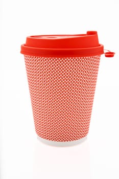 The pink cardboard coffee cup with a red plastic lid on the white glossy background, the inscription on the lid is Carefully Hot, transparent background. High quality photo