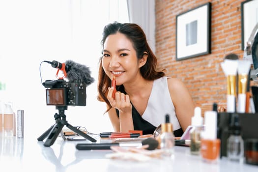 Woman influencer shoot live streaming vlog video review makeup uttermost social media or blog. Happy young girl with cosmetics studio lighting for marketing recording session broadcasting online.