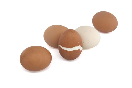 Batch of hard-boiled eggs with varying colors, one of which broke during the boiling process, isolated on a white background