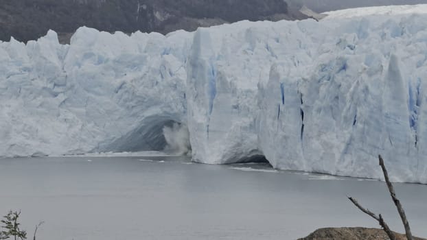 Ice chunks fall from Perito Moreno Glacier's cave into the water below.