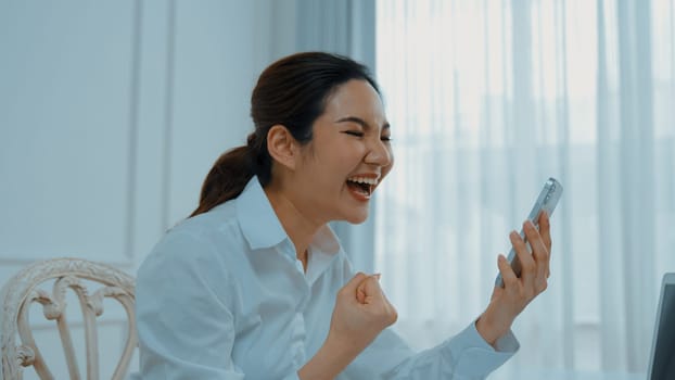 Young woman using smartphone browsing for online shopping E commerce by online payment gateway at vivancy home. Modern and convenience online purchasing make secure and convenient purchases.