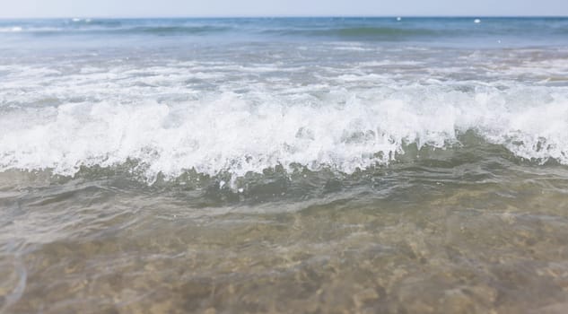 Closeup of sea wave with white foam background. Summer rest concept