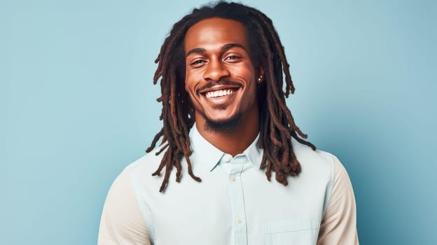 Portrait elegant sexy smiling African man with dark and perfect skin and long hair, on a light blue background. Advertising of cosmetic products, spa treatments shampoos and hair care products, dentistry and medicine, perfumes and cosmetology for men