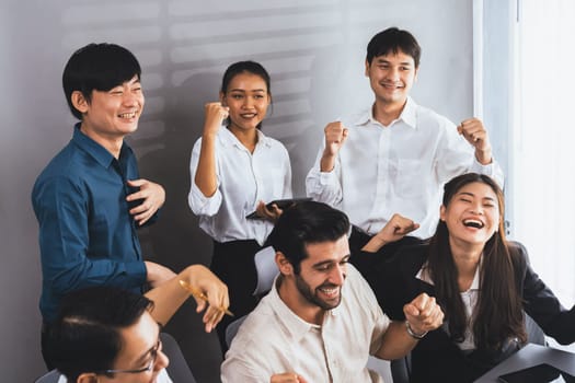 Excited and happy office worker employee celebrate after make successful strategic business marketing planning. Teamwork and positive attitude create productive and supportive workplace. Prudent