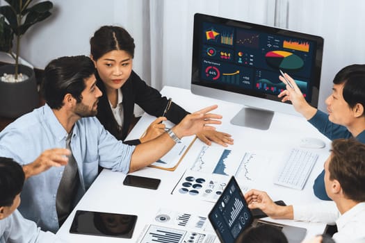 Analyst team utilizing BI Fintech to analyze financial data at table in meeting room. Businesspeople analyzing BI dashboard power on paper for business insight and strategic marketing planning.Prudent