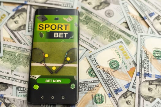 Smartphone with gambling mobile application with money close-up. Sport and betting concept. High quality photo