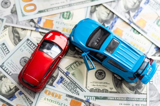 Toy Cars Put on american banknotes.Concept of saving Money to buy and insurance new car. High quality photo