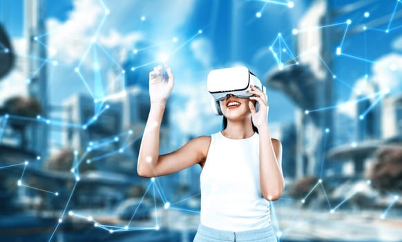 Female stand wear white VR headset and white sleeveless connect metaverse, future technology create cyberspace community. She use index finger touch hologram object of virtual reality. Hallucination.