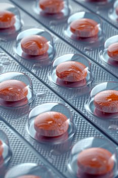 tablets in a blister pack on a blue background , medicines. Packages with vitamins.