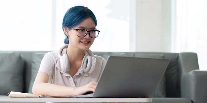 Happy young woman looking at laptop making note, girl student talking by video conference call, female teacher trainer tutor by webcam, online training.