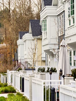 Frontside of brand new residential townhouses. Row of townhouses for sale.