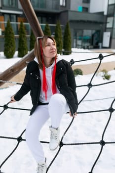 Lifestyle concept, Caucasian woman walking on the playground in the cold.