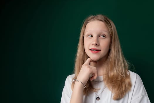 A woman wearing a white shirt is striking a pose for a photograph. She appears confident and relaxed, posing gracefully for the camera.