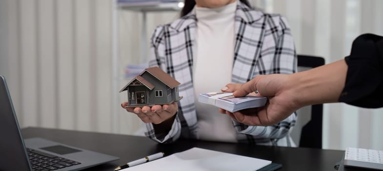 real estate broker Agents deliver sample homes and home contract documents to customers. Concept of buying and selling houses and getting real estate insurance..