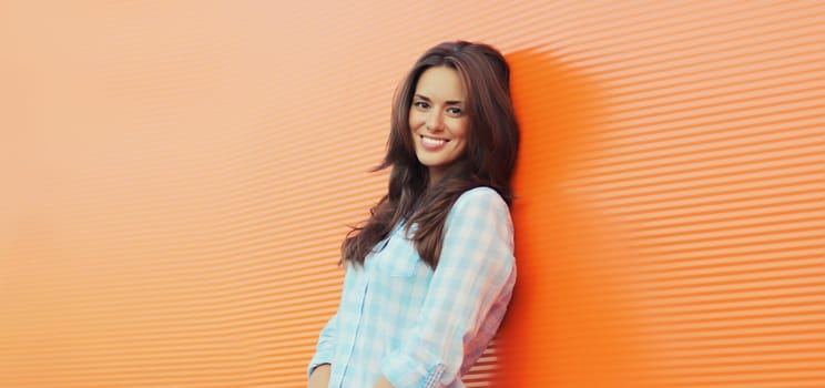 Portrait of beautiful happy smiling brunette young woman posing in the city