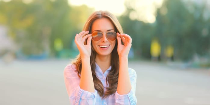 Portrait of beautiful happy smiling brunette young woman posing in the city