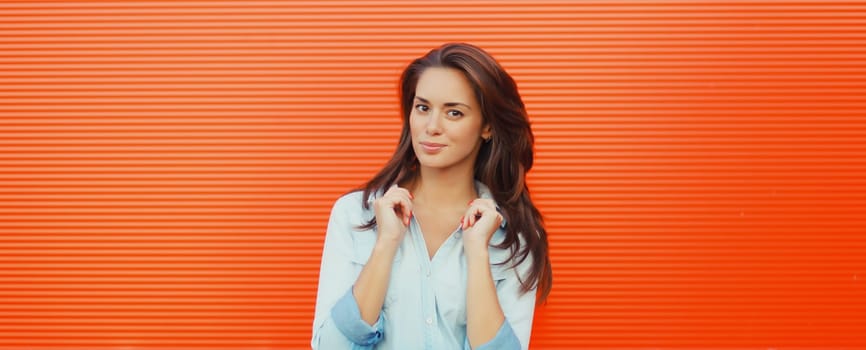 Portrait of beautiful happy smiling brunette young woman posing in the city