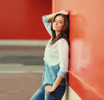 Portrait of beautiful happy smiling brunette young woman posing in the city