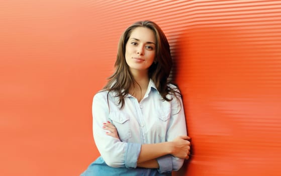 Portrait of beautiful happy smiling brunette young woman posing in the city
