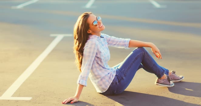 Portrait of beautiful happy smiling brunette young woman posing in the city