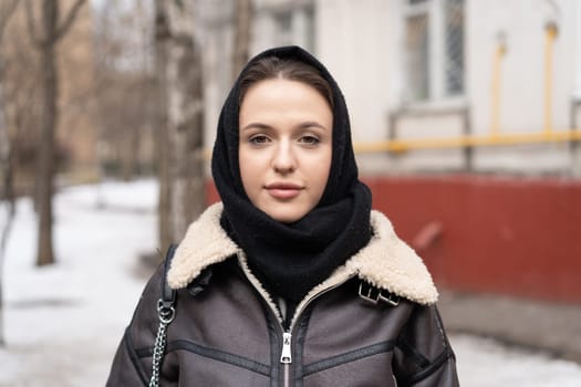 portrait of a young beautiful woman outside wearing a headscarf