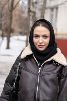 portrait of a young beautiful woman outside wearing a headscarf