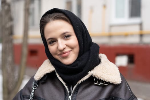 portrait of a young beautiful woman outside wearing a headscarf