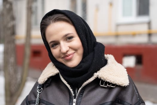 portrait of a young beautiful woman outside wearing a headscarf