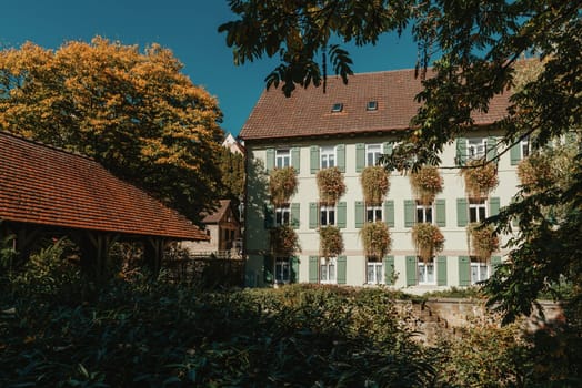 Old national German town house. Old Town is full of colorful and well preserved buildings. Baden-Wurttemberg is a state in southwest Germany bordering France and Switzerland. The Black Forest, known for its evergreen scenery and traditional villages, lies in the mountainous southwest. Stuttgart, the capital, is home to Wilhelma, a royal estate turned zoo and gardens. Porsche and Mercedes-Benz have headquarters and museums there. The 19th-century Hohenzollern Castle sits in the Swabian Alps to the south.