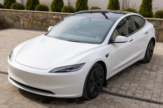 New luxury hybrid white car. White electric sedan car standing in a road. Fleet of generic modern electric cars. Transportation. Luxury car fleet.