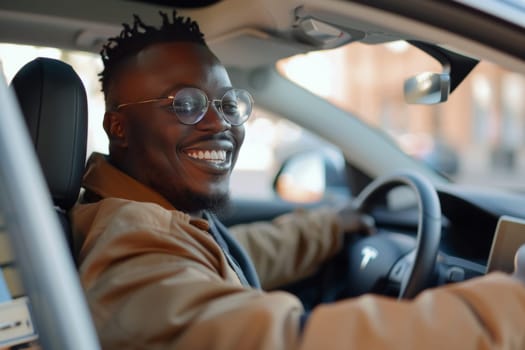 A cheerful African American man beams with satisfaction as he takes a new car for a test drive, enjoying the experience behind the wheel