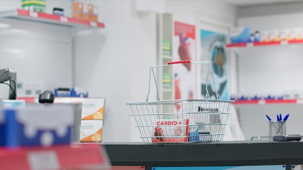 Empty drugstore cash register with boxes of pills or vitamins, having pharmaceutical products and medical supplies for sale on shelves. Pharmacy providing prescription medicine or other treatments.