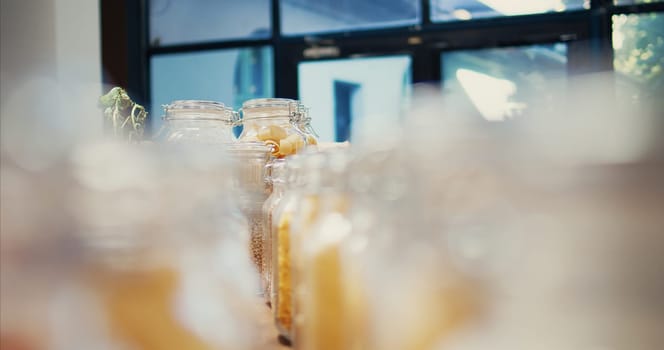 Bulk products in eco friendly zero waste farmers market placed on shelves, nonpolluting organic freshly harvested produce, Advertising sustainable lifestyle and nutrition. Tripod shot. Close up.