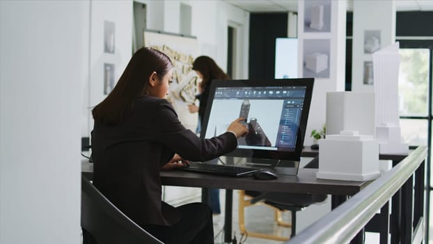 Architect reviewing residential area building plans on pc, working with interactive screen to design and outline property elements. Technician preparing for project in startup coworking space.