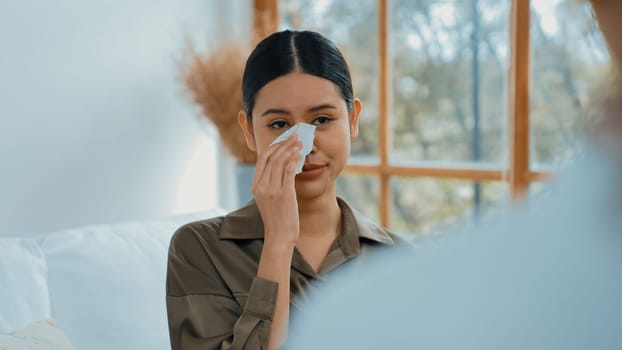 Sad PTSD woman patient in therapy for mental health with psychologist, depression or grief after life failure. Frustrated trauma young woman talking to vivancy psychologist about emotion in clinic