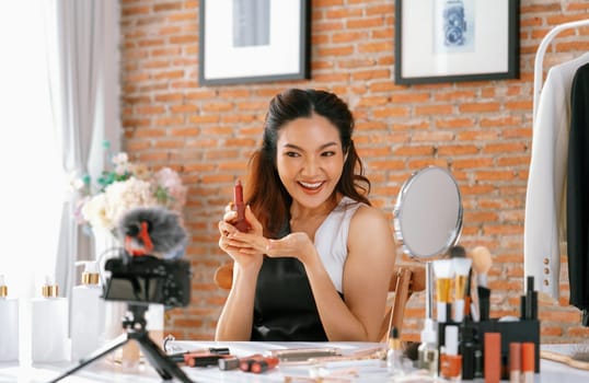 Woman influencer shoot live streaming vlog video review makeup uttermost social media or blog. Happy young girl with cosmetics studio lighting for marketing recording session broadcasting online.