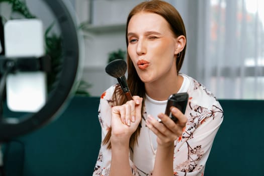 Woman influencer shoot live streaming vlog video review makeup utmost social media or blog. Happy young girl with cosmetics studio lighting for marketing recording session broadcasting online.