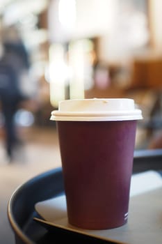 Blank take away kraft coffee cup on table