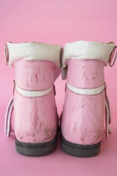 closeup of child dirty white shoe on pink background ,.