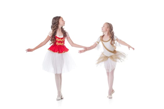 Cute young ballerinas looking at each other while dancing