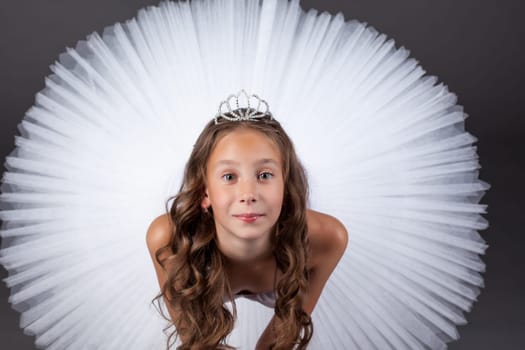 Top view of young ballerina posing looking at camera