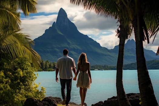 A couple on a tropical island strolling along the beach.