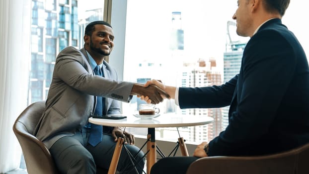 Ornament office with cityscape view, business college or corporate consultant greeting with handshake or shake hand after seal corporate agreement deal for business partnership cooperation