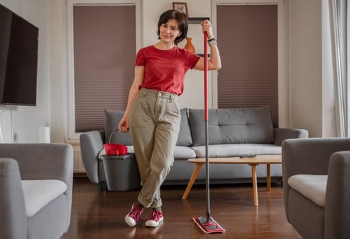Cheerful Cleaner Stands In Room With Mop And Bucket, Washing Floor