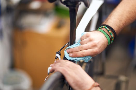 Close up of male mechanic working in bicycle workshop. Bike service, repair and upgrade