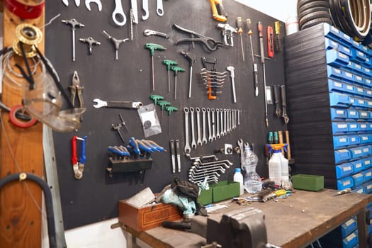 Stand with work tools in professional bicycle workshop. High quality photo