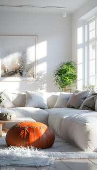 A cozy living room with a hardwood floor, a comfortable couch, ottoman, and coffee table. A plant sits by the window, adding a touch of nature to the room