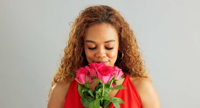 Happy woman, roses and valentines day with flowers for love, care or romance on a gray studio background. Portrait of female person with smile, bouquet and plant for romantic gift on mockup space.