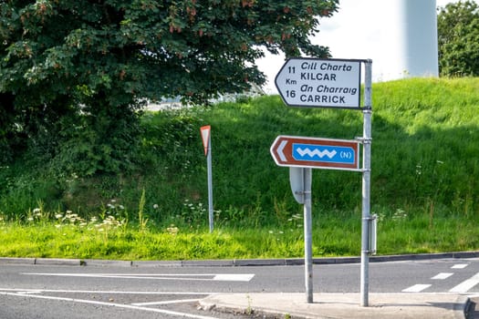 KILLYBEGS, IRELAND - MAY 16 2023: The sign at the roundabout is showing the way to Kilcar and Carrick.